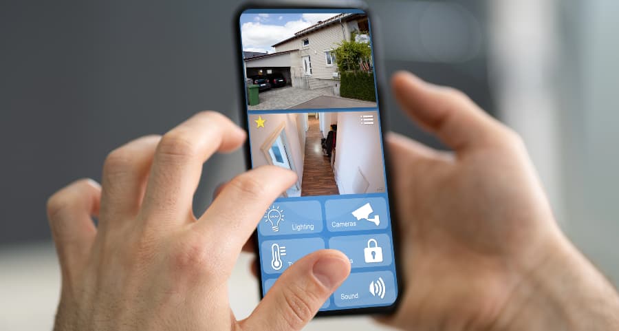 Person looking at surveillance camera streams on a mobile device